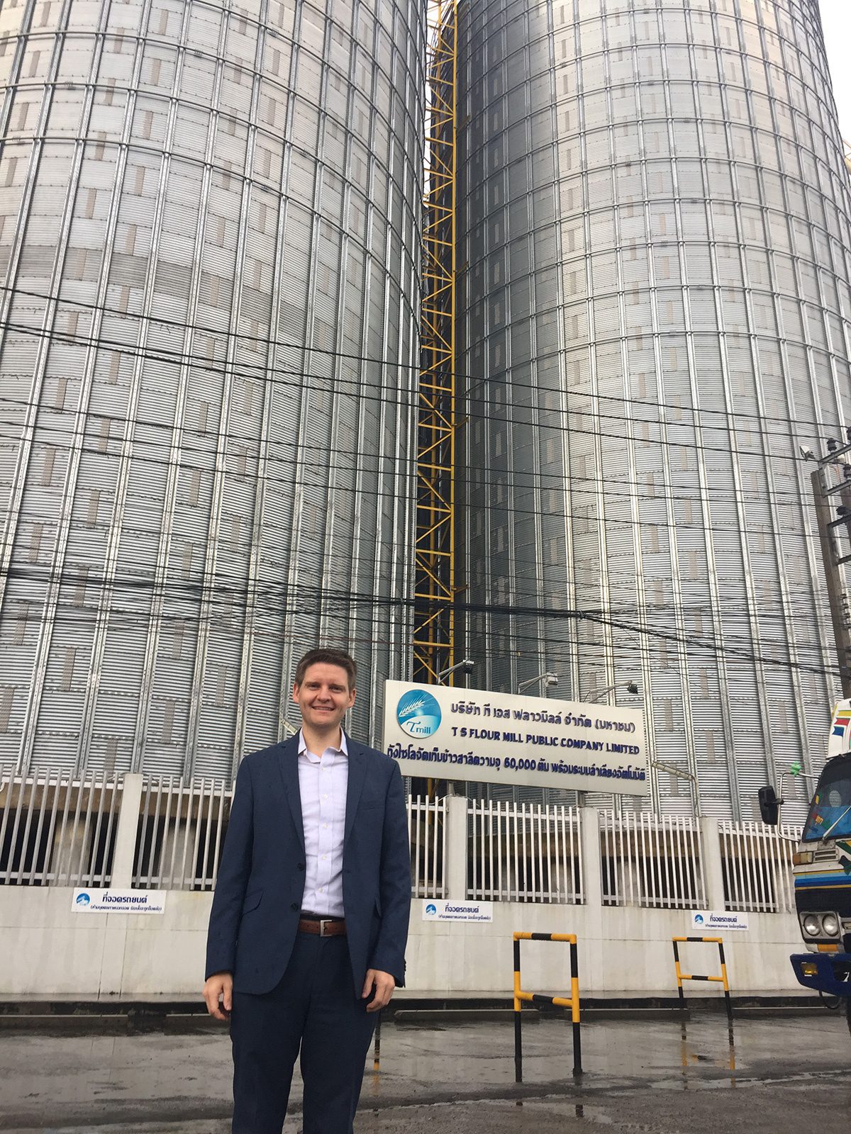 man in front of two tall buildings